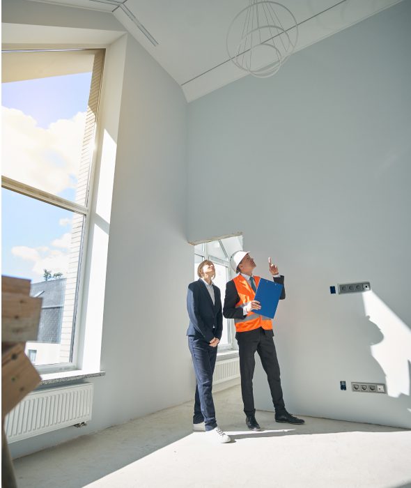 Builders evaluating interior space