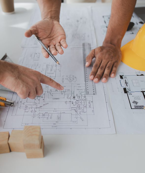 Engineers discussing blueprint details