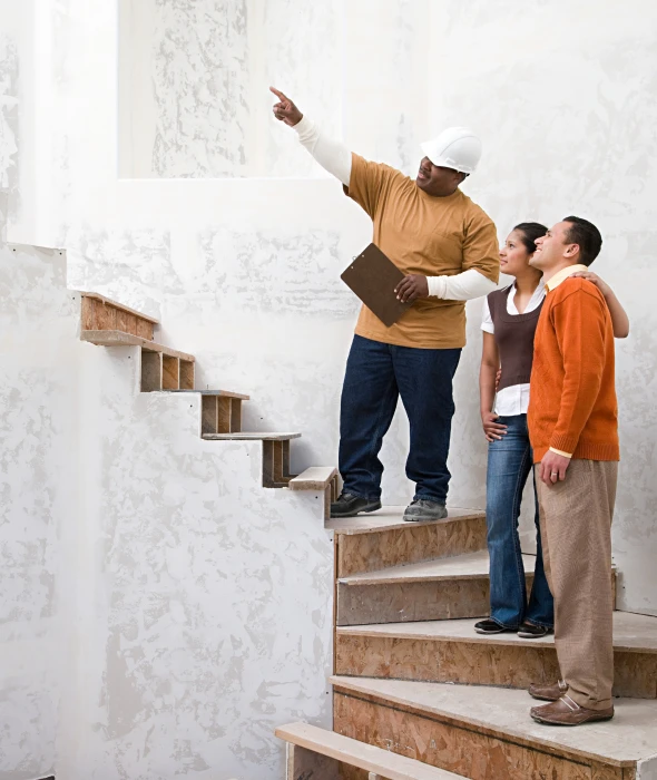 Builder showing new staircase to couple